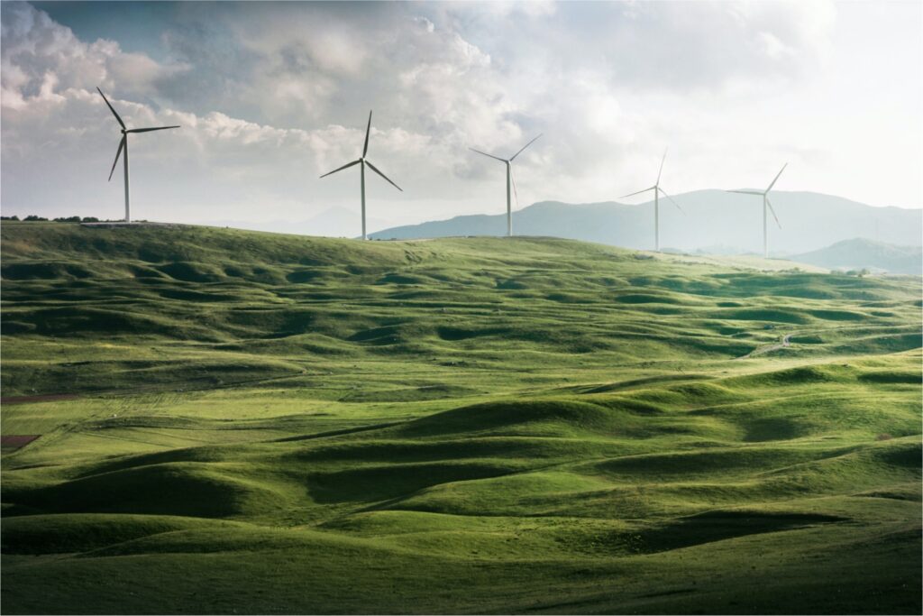 AMPL in Enterprise supports the work of industries such as renewable energy - Picture shows wind turbines in green field.