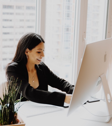 Woman smiling and work on her computer