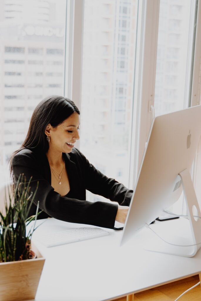 Woman working on computer development city office