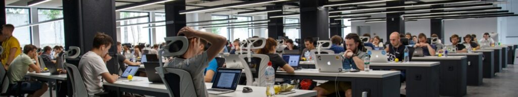 People working on computers large indoor office