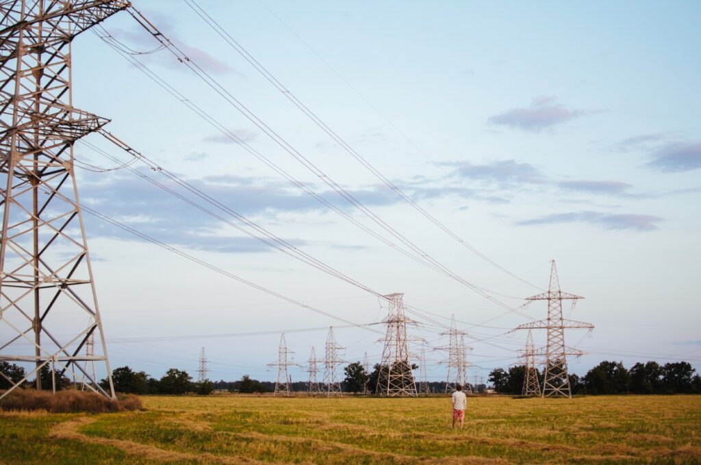 Power grid in a field on a clear day